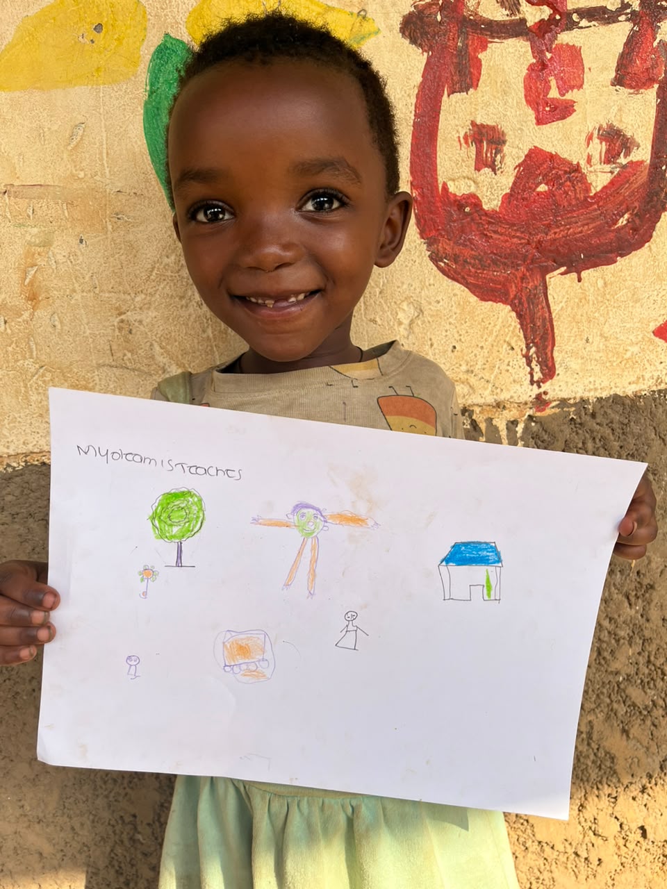 A child of the Inzozi Learning Center holding their dream drawing (5)