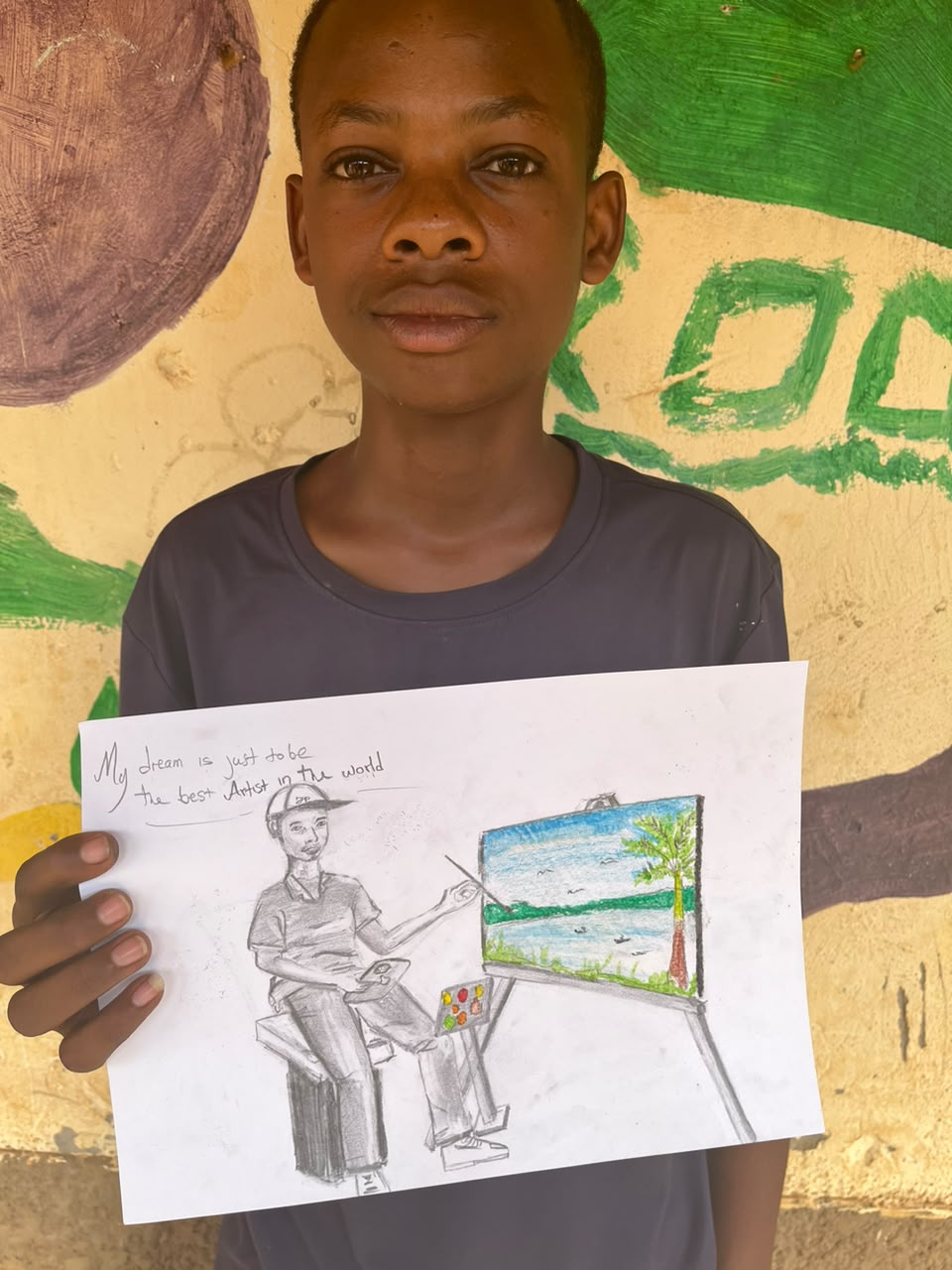 A child of the Inzozi Learning Center holding their dream drawing (11)