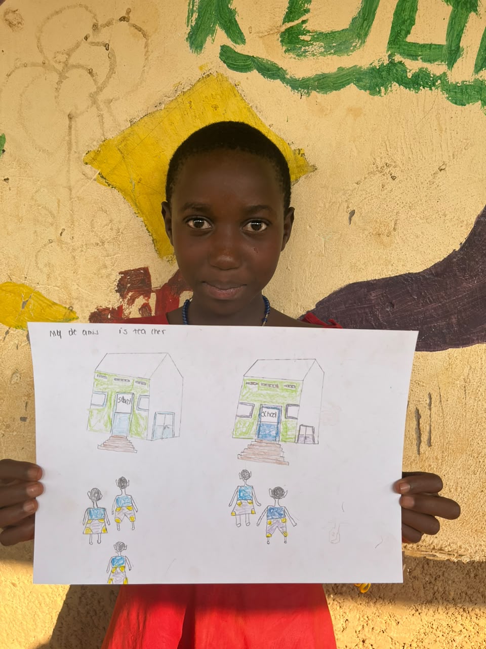 A child of the Inzozi Learning Center holding their dream drawing (16)