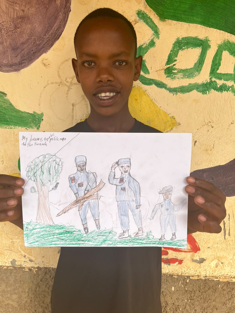 A child of the Inzozi Learning Center holding their dream drawing (8)