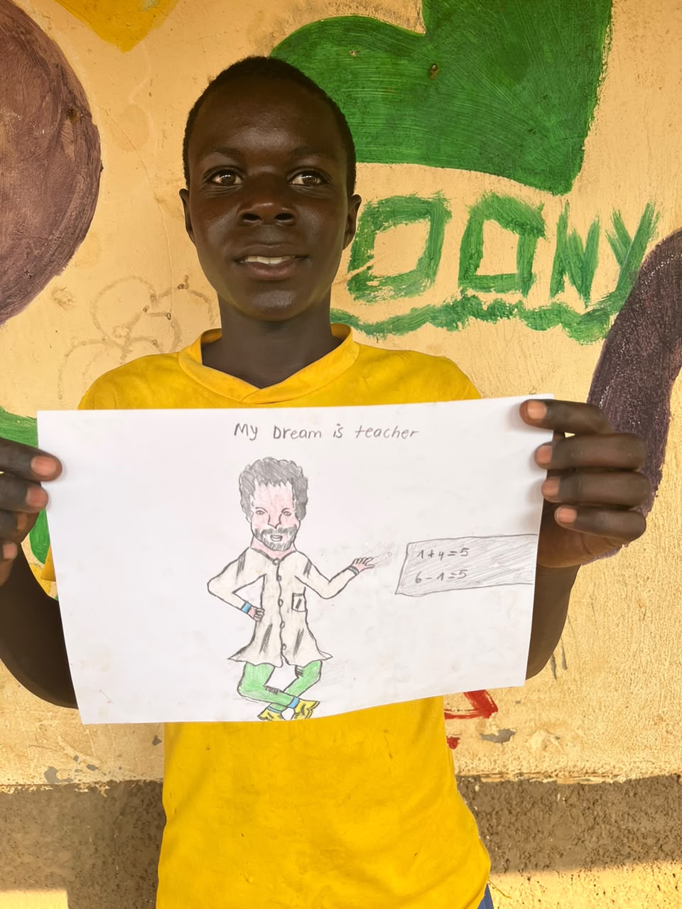 A child of the Inzozi Learning Center holding their dream drawing (12)